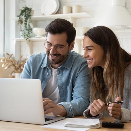 Couple looking at investments on a laptop computer