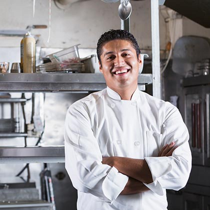 Business owner standing in his restaurant's kitchen